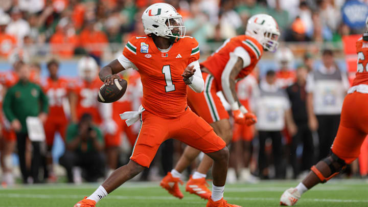 Dec 28, 2024; Orlando, FL, USA; Miami Hurricanes quarterback Cam Ward (1) drops back to pass against the Iowa State Cyclones in the first quarter during the Pop Tarts bowl at Camping World Stadium.  