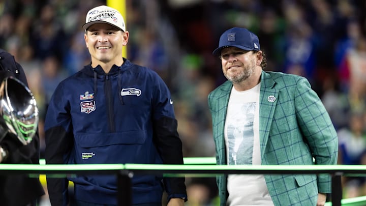 Seattle Seahawks head coach Mike MacDonald celebrates with general manager John Schneider.
