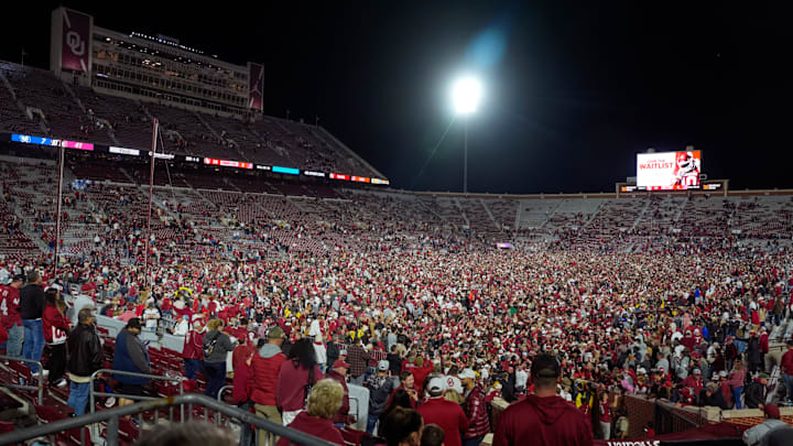 Fans rush the field after a college football game between the University of Oklahoma Sooners (OU) and the Alabama Crimson Tide at Gaylord Family - Oklahoma Memorial Stadium in Norman, Okla., Saturday, Nov. 23, 2024. Oklahoma won 24-3.
