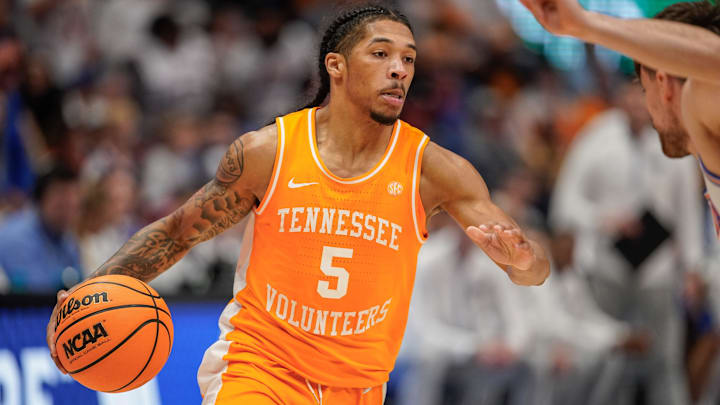 Tennessee guard Zakai Zeigler (5) looks for a path around Florida defenders during the second half of the Southeastern Conference tournament championship at Bridgestone Arena in Nashville, Tenn., Sunday, March 16, 2025.