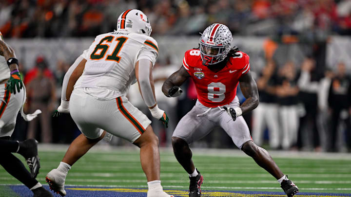 Dec 31, 2025; Arlington, TX, USA; Miami Hurricanes offensive lineman Francis Mauigoa (61) blocks Ohio State Buckeyes linebacker Arvell Reese (8) during the 2025 Cotton Bowl and quarterfinal game of the College Football Playoff at AT&T Stadium. Mandatory Credit: Jerome Miron-Imagn Images