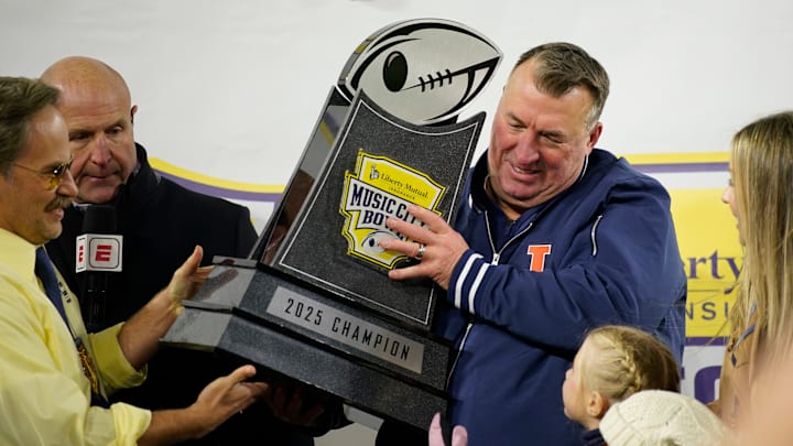 Illinois coach Bret Bielema is presented with the Music City Bowl trophy after defeating Tennessee in an NCAA college football game on Dec. 30, 2025, in Nashville, Tennessee.