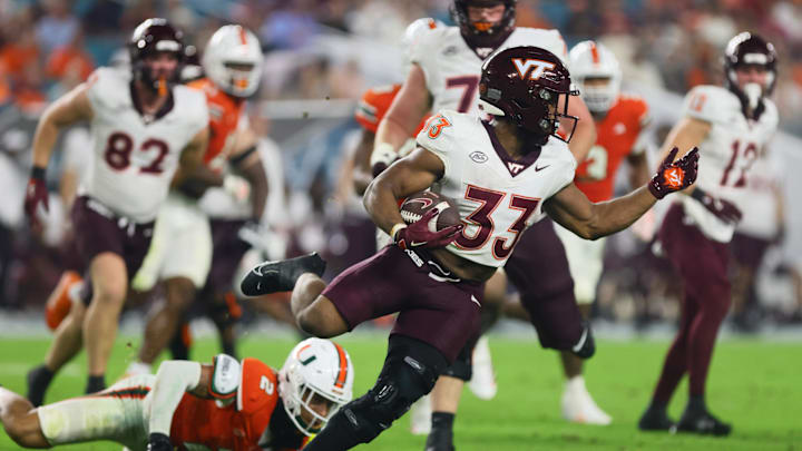 Virginia Tech Hokies running back Bhayshul Tuten (33) runs with the football against the Miami Hurricanes during the third quarter at Hard Rock Stadium. 