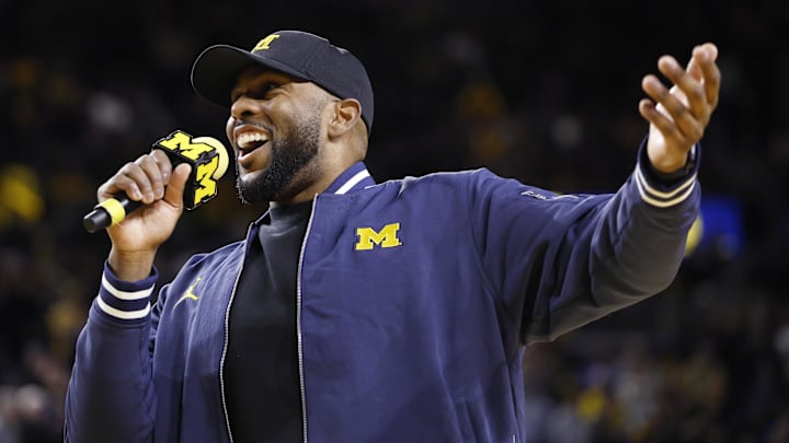 Jan 19, 2025; Ann Arbor, Michigan, USA;  Michigan Wolverines head football coach Sherrone Moore fires up the crowd in overtime of the basketball game against the Northwestern Wildcats at Crisler Center. Mandatory Credit: Rick Osentoski-Imagn Images