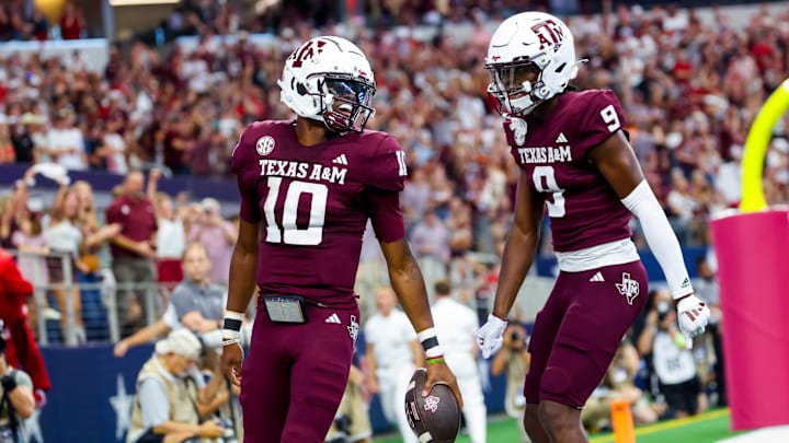 Texas A&M Aggies quarterback Marcel Reed (10) celebrates with Texas A&M Aggies wide receiver Jahdae Walker (9) after scoring a touchdown during the first half against the Arkansas Razorbacks at AT&T Stadium.