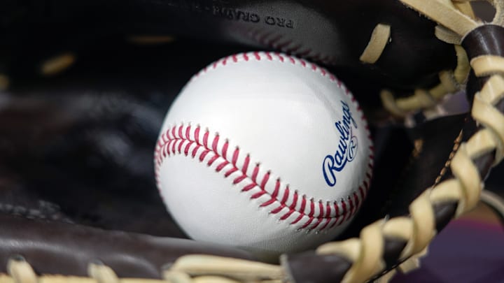 Apr 18, 2025; Milwaukee, Wisconsin, USA;  General view of a baseball in a glove during batting practice prior to the game between the Athletics and Milwaukee Brewers at American Family Field. Mandatory Credit: Jeff Hanisch-Imagn Images