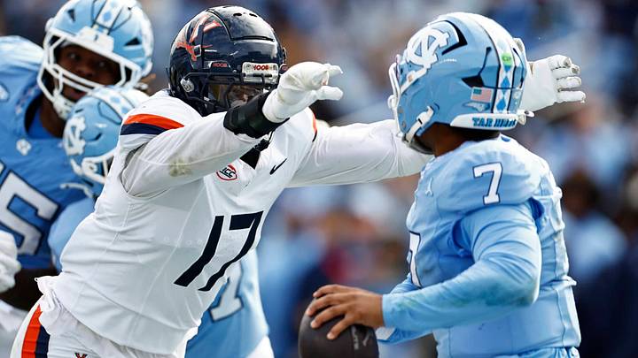 Virginia Cavaliers defensive end Mitchell Melton (17) pressures North Carolina Tar Heels quarterback Gio Lopez (7) in a 17-16 Cavaliers win in Chapel Hill, N.C. Oct. 25, 2025. Virginia Cavaliers defensive end Mitchell Melton (17) pressures North Carolina Tar Heels quarterback Gio Lopez (7) in a 17-16 Cavaliers win in Chapel Hill, N.C. Oct. 25, 2025.