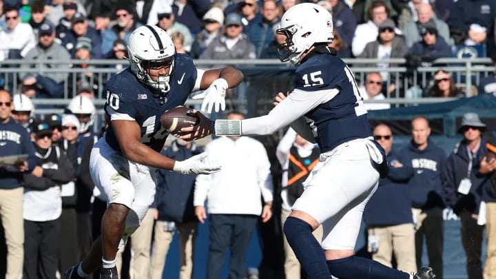 Penn State quarterback Drew Allar hands off to running back Nicholas Singleton during the first half against the Rutgers Scarlet Knights at Beaver Stadium. Penn State quarterback Drew Allar hands off to running back Nicholas Singleton during the first half against the Rutgers Scarlet Knights at Beaver Stadium.