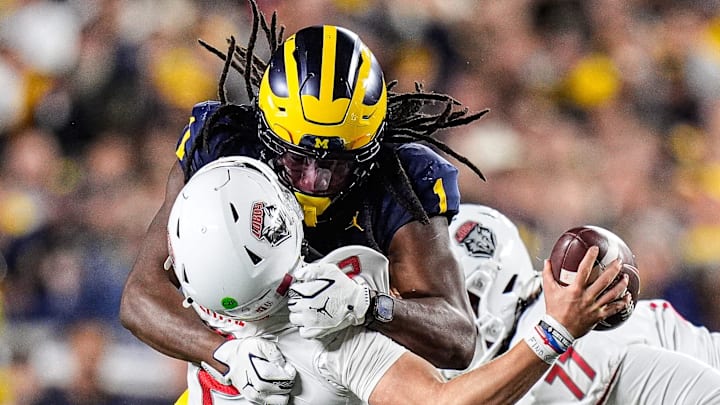 Michigan linebacker Jaishawn Barham (1) tackles New Mexico quarterback Jack Layne (2) during the second half at Michigan Stadium in Ann Arbor on Saturday, August 30, 2025.
