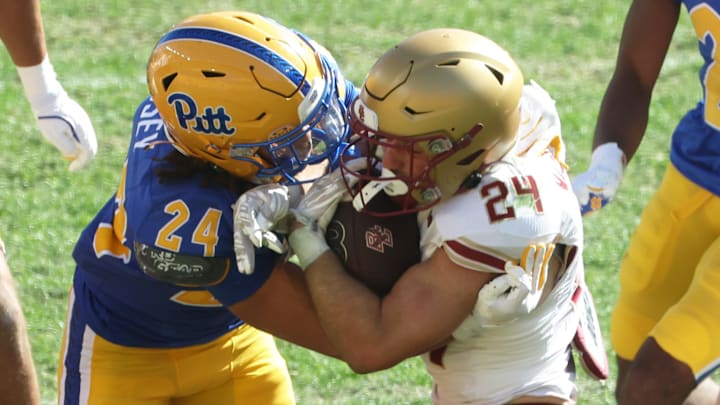 Oct 4, 2025; Pittsburgh, Pennsylvania, USA; Pittsburgh Panthers linebacker Cameron Lindsey (24 left) tackles Boston College Eagles running back Bo MacCormack III (24 right) during the fourth quarter at Acrisure Stadium. Mandatory Credit: Charles LeClaire-Imagn Images Oct 4, 2025; Pittsburgh, Pennsylvania, USA; Pittsburgh Panthers linebacker Cameron Lindsey (24 left) tackles Boston College Eagles running back Bo MacCormack III (24 right) during the fourth quarter at Acrisure Stadium. Mandatory Credit: Charles LeClaire-Imagn Images