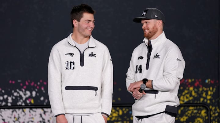 Feb 2, 2026; San Jose, CA, USA; Seattle Seahawks quarterback Sam Darnold (14) and New England Patriots quarterback Drake Maye (10) look on during Opening Night for Super Bowl LX at San Jose Convention Center. 