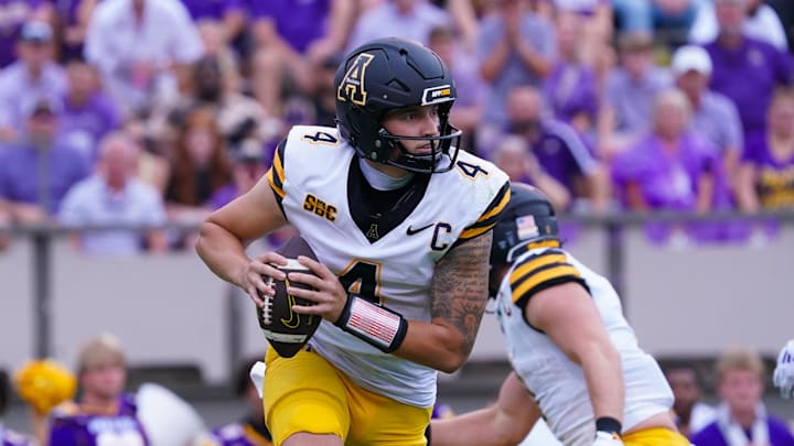 Sep 14, 2024; Greenville, North Carolina, USA;  Appalachian State Mountaineers quarterback Joey Aguilar (4) rolls out of the pocket against the East Carolina Pirates during the first half at Dowdy-Ficklen Stadium. Mandatory Credit: James Guillory-Imagn Images