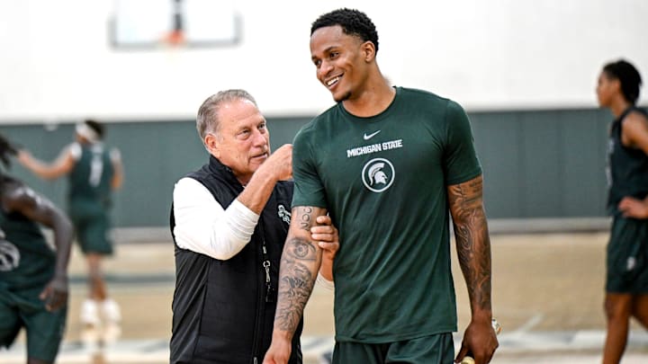 Michigan State's coach Tom Izzo, left, jokes with injured transfer Kaleb Glenn during the first day of basketball practice on Monday, Sept. 22, 2025, at the Breslin Center in East Lansing.