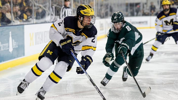 Michigan left wing Rutger McGroarty looks to pass against Michigan State defenseman Maxim Strbak during the third period at Yost Ice Arena in Ann Arbor on Friday, Feb. 9, 2024.