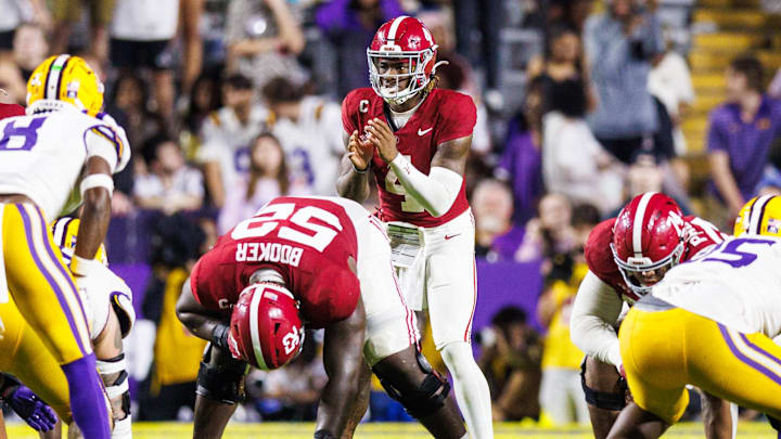 Nov 9, 2024; Baton Rouge, Louisiana, USA;  Alabama Crimson Tide quarterback Jalen Milroe (4) calls for the ball against LSU Tigers safety Major Burns (8) during the second half at Tiger Stadium. Mandatory Credit: Stephen Lew-Imagn Images