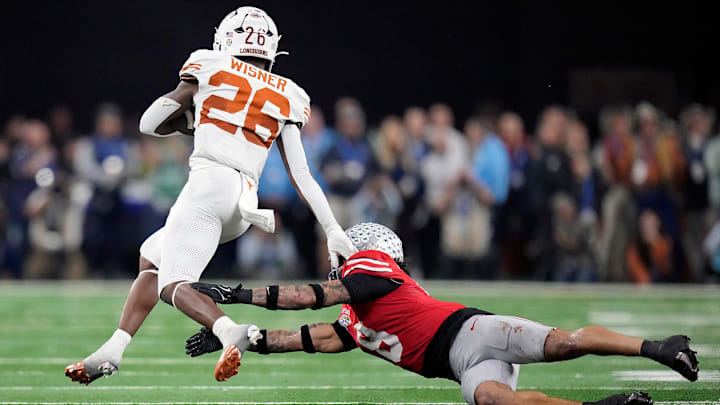 Texas Longhorns running back Quintrevion Wisner (26) gets past Ohio State Buckeyes safety Lathan Ransom (8) on a run in the third quarter
