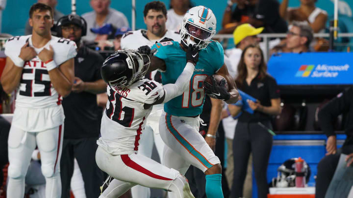 Wide receiver Erik Ezukanma stiff arms Atlanta Falcons defensive back Breon Borders during a 2023 preseason game at Hard Rock Stadium.