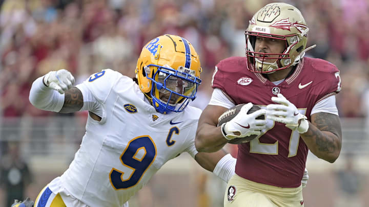 Oct 11, 2025; Tallahassee, Florida, USA; Florida State Seminoles running back Gavin Sawchuk (27) runs the ball past Pittsburgh Panthers linebacker Kyle Louis (9) during the first half at Doak S. Campbell Stadium. Mandatory Credit: Melina Myers-Imagn Images