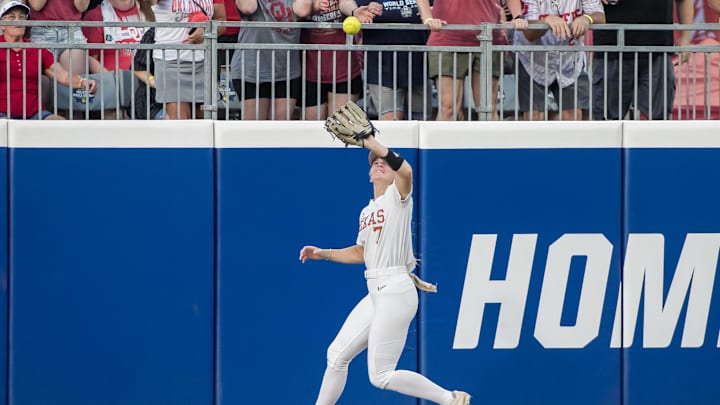 Jun 6, 2024; Oklahoma City, OK, USA;  Texas Longhorns outfielder Ashton Maloney (7) makes a catch at the wall in the third inning against the Oklahoma Sooners during game two of the Women's College World Series softball championship finals at Devon Park. Mandatory Credit: Brett Rojo-Imagn Images