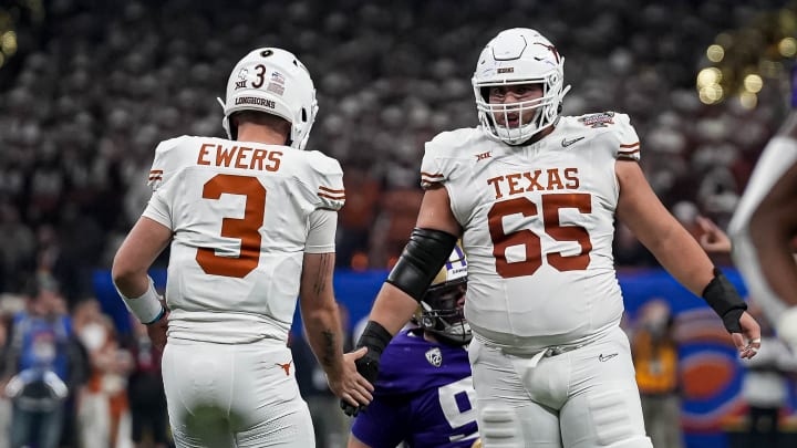Texas Longhorns offensive lineman Jake Majors (65) celebrates a first down with quarterback Quinn Ewers (3) during the Sugar Bowl College Football Playoff semifinals game against the Washington Huskies at the Caesars Superdome on Monday, Jan. 1, 2024 in New Orleans, Louisiana.
