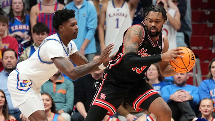Jan 25, 2025; Lawrence, Kansas, USA; Houston Cougars forward J'Wan Roberts (13) controls the ball as Kansas Jayhawks guard AJ Storr (2) defends during the second half at Allen Fieldhouse. Mandatory Credit: Denny Medley-Imagn Images