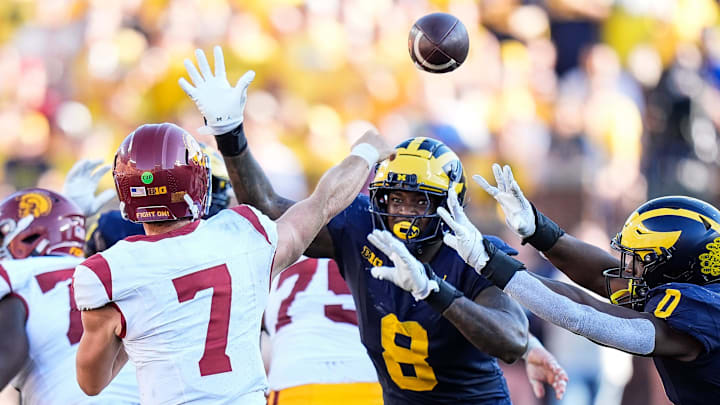 USC quarterback Miller Moss (7) makes a pass against Michigan defensive end Derrick Moore (8) during the second half at Michigan Stadium in Ann Arbor on Saturday, Sept. 21, 2024.