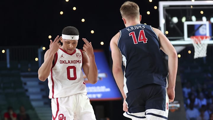 Nov 28, 2024;  Paradise Island, Bahamas, BHS; Oklahoma Sooners guard Jeremiah Fears (0) reacts in front of Arizona Wildcats center Motiejus Krivas (14) after scoring during the second half  in the Imperial Arena at the Atlantis Resort. 
