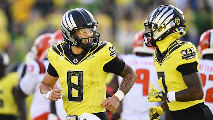 Oct 26, 2024; Eugene, Oregon, USA; Oregon Ducks quarterback Dillon Gabriel (8) celebrates with wide receiver Evan Stewart (7) after scoring a touchdown during the first half against Illinois Fighting Illini at Autzen Stadium. Mandatory Credit: Troy Wayrynen-Imagn Images