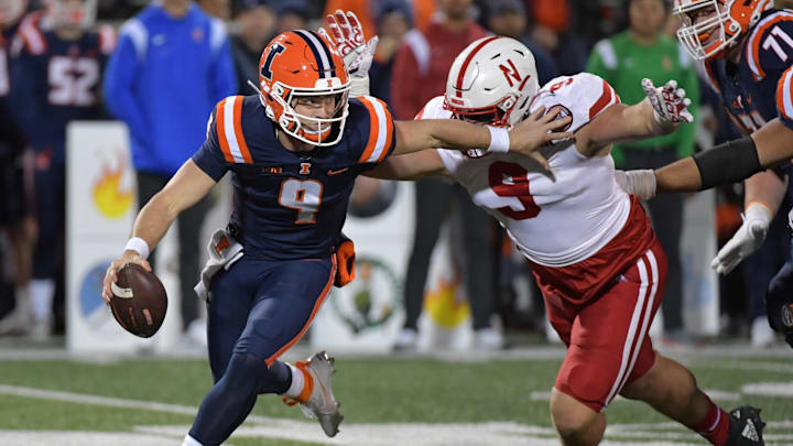 Oct 6, 2023; Champaign, Illinois, USA; Illinois Fighting Illini quarterback Luke Altmyer is pursued by Nebraska Cornhuskers defensive lineman Ty Robinson during the second half.