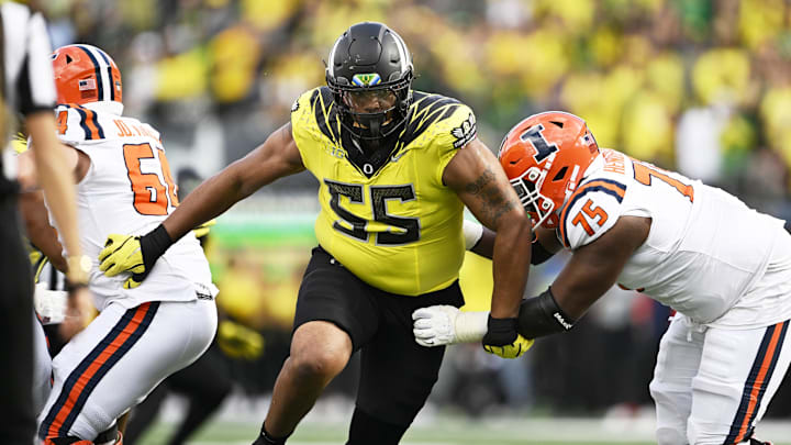 Oct 26, 2024; Eugene, Oregon, USA; Oregon Ducks defensive lineman Derrick Harmon (55) breaks past Illinois Fighting Illini offensive lineman Brandon Henderson (75) during the second half at Autzen Stadium. Mandatory Credit: Troy Wayrynen-Imagn Images