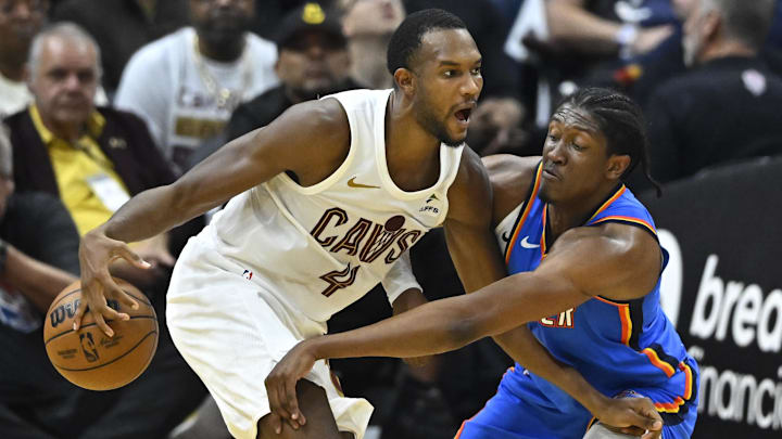 Oct 27, 2023; Cleveland, Ohio, USA; Oklahoma City Thunder forward Jalen Williams (8) hits the ball from Cleveland Cavaliers forward Evan Mobley (4) in the second quarter at Rocket Mortgage FieldHouse. Mandatory Credit: David Richard-Imagn Images