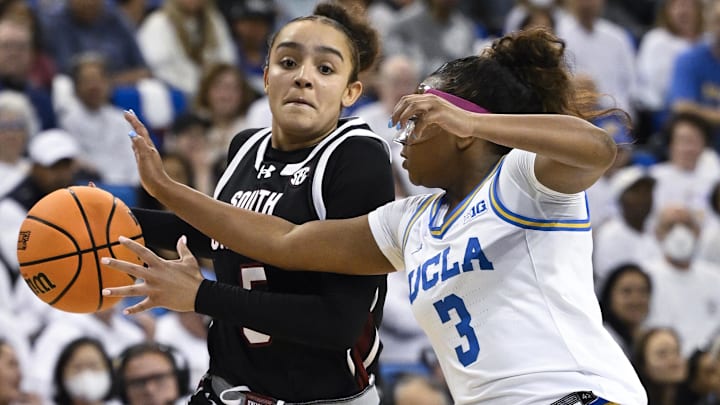Nov 24, 2024; Los Angeles, California, USA; South Carolina Gamecocks guard Tessa Johnson (5) drives to the basket as UCLA Bruins guard Londynn Jones (3) moves in to defend during the third quarter at Pauley Pavilion presented by Wescom. Mandatory Credit: Robert Hanashiro-Imagn Images