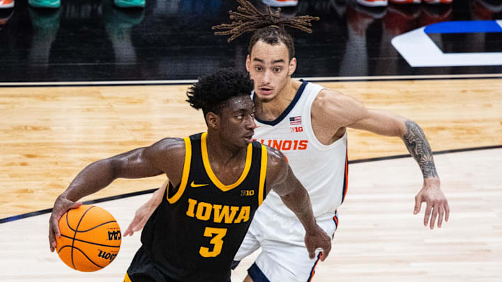 Mar 13, 2025; Indianapolis, IN, USA;  Iowa Hawkeyes guard Drew Thelwell (3) dribbles the ball while  Illinois Fighting Illini guard Dra Gibbs-Lawhorn (2) defends in the first half at Gainbridge Fieldhouse. Mandatory Credit: Trevor Ruszkowski-Imagn Images