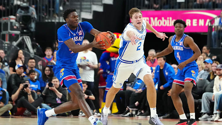 Nov 26, 2024; Las Vegas, Nevada, USA; Kansas Jayhawks forward Flory Bidunga (40) catches a loose ball against Duke Blue Devils guard Cooper Flagg (2) during the first half at T-Mobile Arena. Mandatory Credit: Stephen R. Sylvanie-Imagn Images