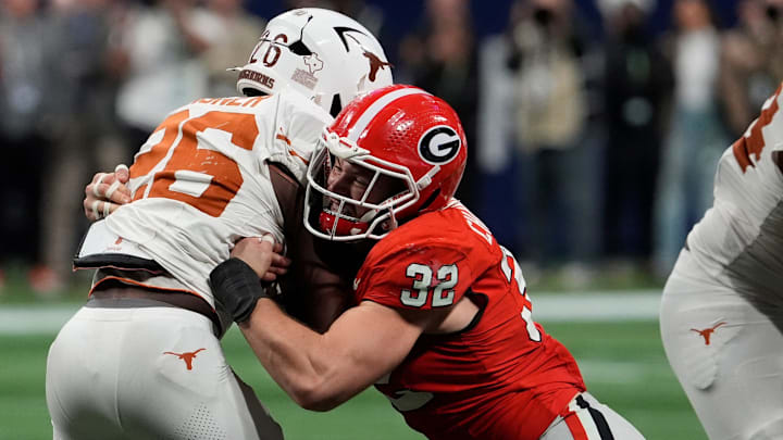 Georgia linebacker Chaz Chambliss (32) stops Texas running back Quintrevion Wisner (26) during the second half of the SEC championship game against Texas. Georgia linebacker Chaz Chambliss (32) stops Texas running back Quintrevion Wisner (26) during the second half of the SEC championship game against Texas.