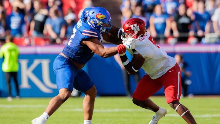 Oct 19, 2024; Kansas City, Missouri, USA; Kansas Jayhawks offensive lineman Logan Brown (52) faces off with Houston Cougars defensive lineman Keith Cooper Jr. (5) during the second quarter at GEHA Field at Arrowhead Stadium. Oct 19, 2024; Kansas City, Missouri, USA; Kansas Jayhawks offensive lineman Logan Brown (52) faces off with Houston Cougars defensive lineman Keith Cooper Jr. (5) during the second quarter at GEHA Field at Arrowhead Stadium.