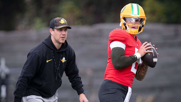 Oregon quarterback Dillon Gabriel throws out a pass as offensive coordinator Will Stein during practice with the Oregon Ducks Tuesday, Aug. 27, 2024 at the Hatfield-Dowlin Complex in Eugene, Ore.