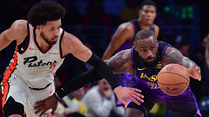 Dec 23, 2024; Los Angeles, California, USA; Los Angeles Lakers forward LeBron James (23) plays for the ball against Detroit Pistons guard Cade Cunningham (2) during the first half at Crypto.com Arena. Mandatory Credit: Gary A. Vasquez-Imagn Images
