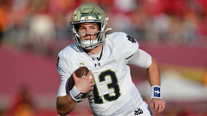 Nov 30, 2024; Los Angeles, California, USA; Notre Dame Fighting Irish quarterback Riley Leonard (13) runs the ball against the Southern California Trojans during the second half at the Los Angeles Memorial Coliseum. Mandatory Credit: Gary A. Vasquez-Imagn Images Nov 30, 2024; Los Angeles, California, USA; Notre Dame Fighting Irish quarterback Riley Leonard (13) runs the ball against the Southern California Trojans during the second half at the Los Angeles Memorial Coliseum. Mandatory Credit: Gary A. Vasquez-Imagn Images