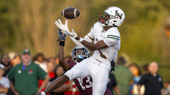 Lawrence North High School sophomore Monshun Sales (1) makes a catch in the end zone to score while being defended by Lawrence Central High School junior DJ Summers (13) during the first half of an IHSAA varsity football game, Friday, Aug. 23, 2024, at Lawrence Central High School.