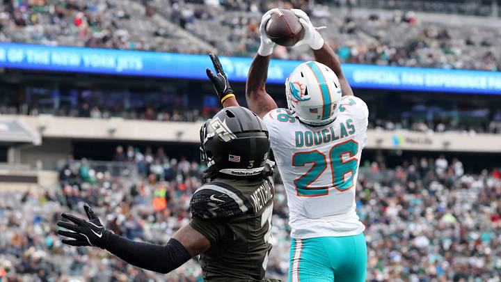 Dec 7, 2025; East Rutherford, New Jersey, USA; Miami Dolphins cornerback Rasul Douglas (26) intercepts the ball against New York Jets wide receiver John Metchie III (3) during the first half at MetLife Stadium. Mandatory Credit: Ed Mulholland-Imagn Images Dec 7, 2025; East Rutherford, New Jersey, USA; Miami Dolphins cornerback Rasul Douglas (26) intercepts the ball against New York Jets wide receiver John Metchie III (3) during the first half at MetLife Stadium. Mandatory Credit: Ed Mulholland-Imagn Images