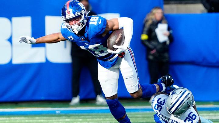 New York Giants wide receiver Darius Slayton (18) breaks a tackle attempt by Dallas Cowboys cornerback Corey Ballentine (36) before getting a Big Blue first down, Sunday, January 4, 2026, in East Rutherford.