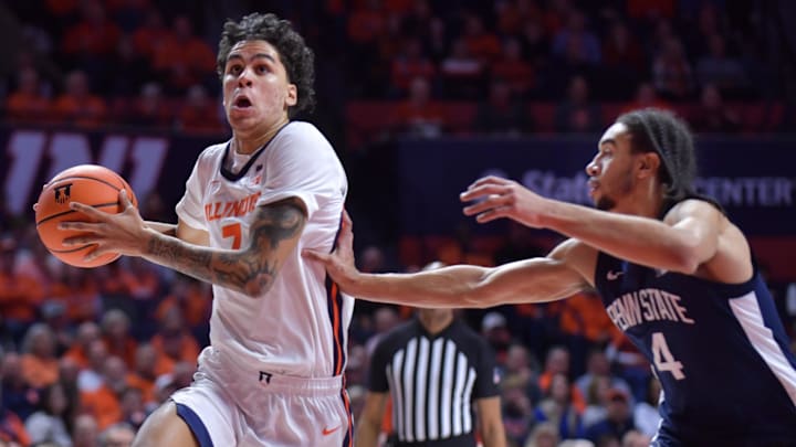 Jan 8, 2025; Champaign, Illinois, USA;  Illinois Fighting Illini forward Will Riley (7) drives past Penn State Nittany Lions guard Freddie Dilione V (4) during the first half at State Farm Center. Mandatory Credit: Ron Johnson-Imagn Images