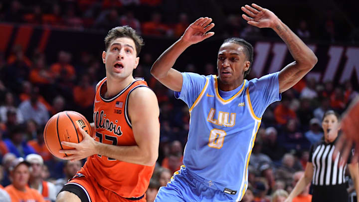 Nov 22, 2025; Champaign, Illinois, USA; Illinois Fighting Illini guard Mihailo Petrovic (77) drives past Long Island University Sharks guard Malachi Davis (0) during the first half at State Farm Center. Mandatory Credit: Ron Johnson-Imagn Images