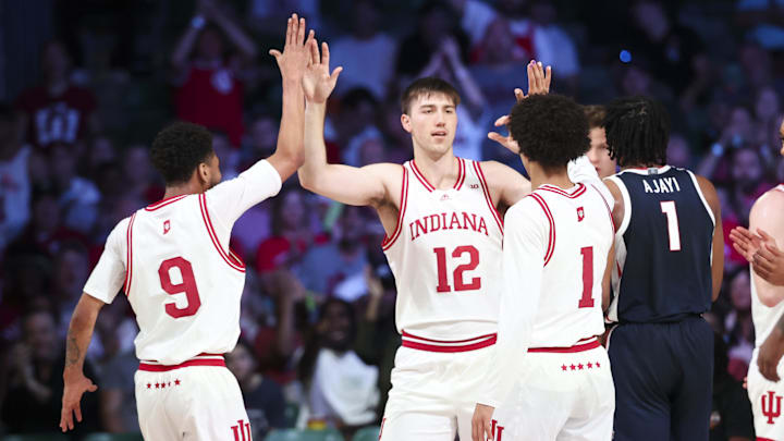 Indiana Hoosiers center Langdon Hatton (12) celebrates with Indiana Hoosiers guard Kanaan Carlyle (9) and Indiana Hoosiers guard Myles Rice (1) during the first half against the Gonzaga Bulldogs at Imperial Arena at the Atlantis resort.