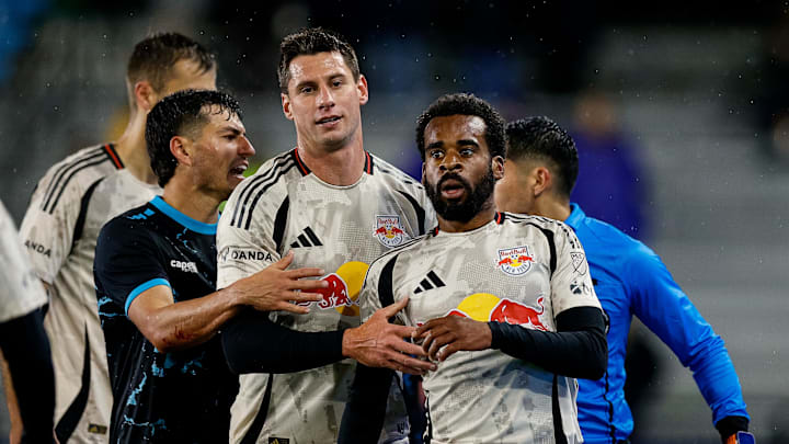 New York Red Bulls defender Raheem Edwards (44) is held back by defender Sean Nealis (15) and Colorado Springs Switchbacks FC midfielder Anthony Fontana (21) 