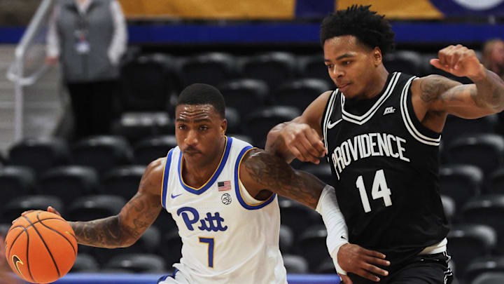 Oct 19, 2025; Pittsburgh, PA, USA;  Pittsburgh Panthers guard Damarco Minor (7) controls the ball against Providence Friars guard Corey Floyd Jr. (14) during the second half at the Petersen Events Center. Mandatory Credit: Charles LeClaire-Imagn Images
