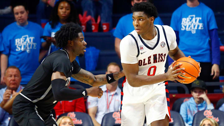 Feb 15, 2025; Oxford, Mississippi, USA; Mississippi Rebels forward Malik Dia (0) handles the ball as Mississippi State Bulldogs forward Cameron Matthews (4) defends during the first half at The Sandy and John Black Pavilion at Ole Miss. Mandatory Credit: Petre Thomas-Imagn Images