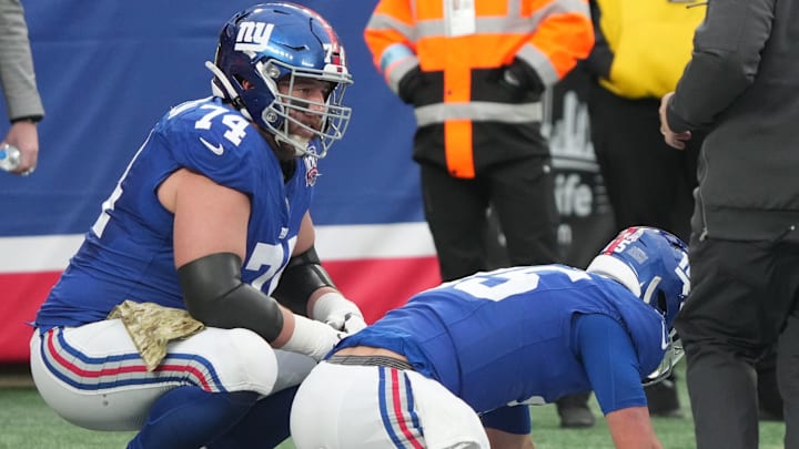 East Rutherford, NJ -- November 24, 2024 -- Tommy DeVito of the Giants gets hit by Calijah Kancey of Tampa Bay after he threw a pass in the fourth quarter. DeVito was injured and came out of the game for one play as the Tampa Bay Buccaneers came to MetLife Stadium and defeated the New York Giants 30-7.