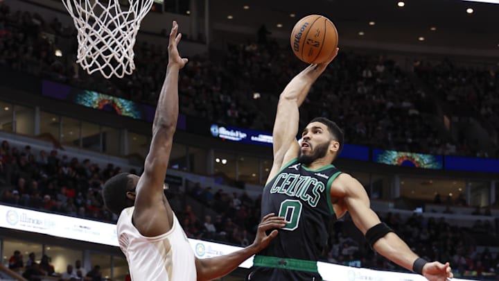 Dec 21, 2024; Chicago, Illinois, USA; Boston Celtics forward Jayson Tatum (0) goes to the basket against Chicago Bulls forward Jalen Smith (7) during the second half at United Center. Mandatory Credit: Kamil Krzaczynski-Imagn Images